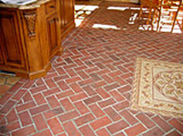 Brick tile floor with mosaic insert