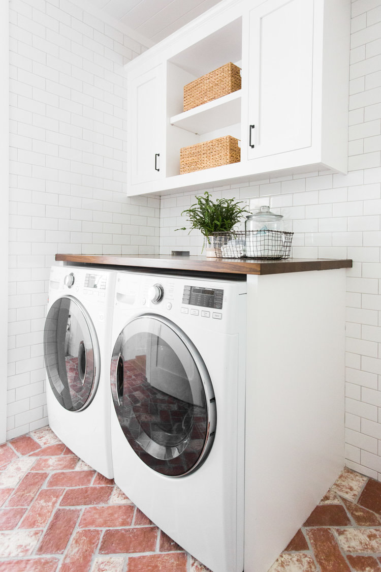 White washed brick tile flooring in laundry room